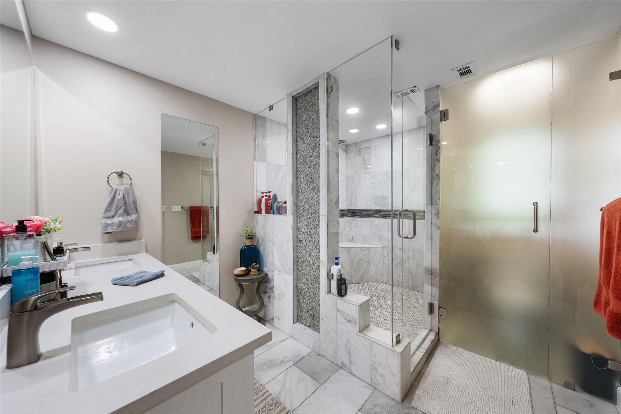 301 Oak Ridge Road Georgetown, TX 78628 - Photo 13 of 34 Spacious bathroom featuring a dual vanity with white countertops, undermount sinks, and brushed nickel faucets