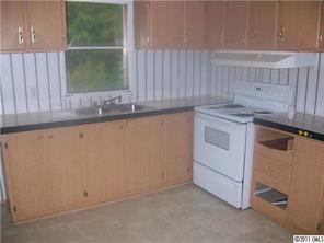 161 Sedberry Road Biscoe, NC 27209 - Photo 3 of 7 a kitchen with granite countertop white cabinets and white appliances