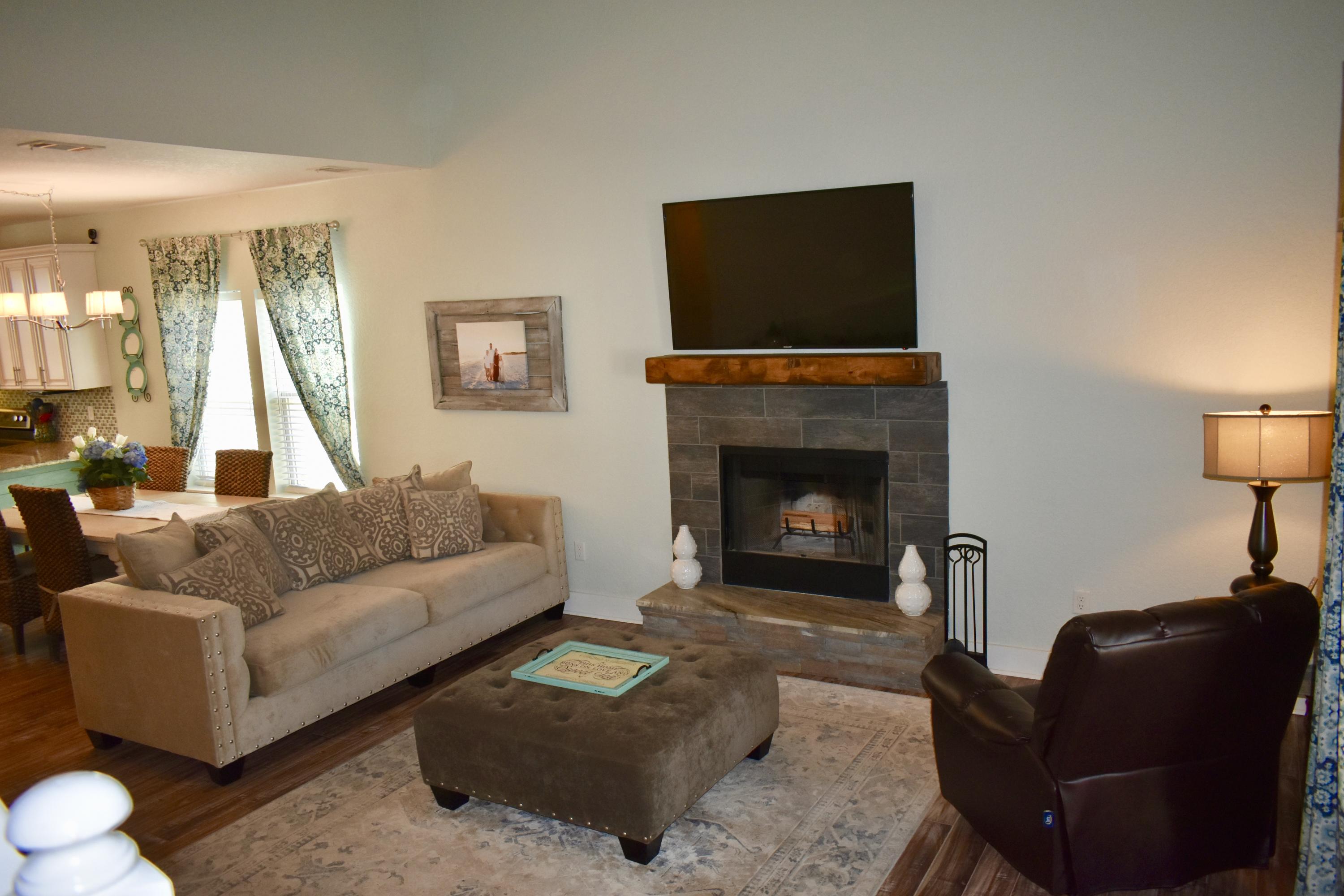 153 Spotted Dolphin Road Santa Rosa Beach, FL 32459 - Photo 14 of 36 a living room with furniture and a fireplace