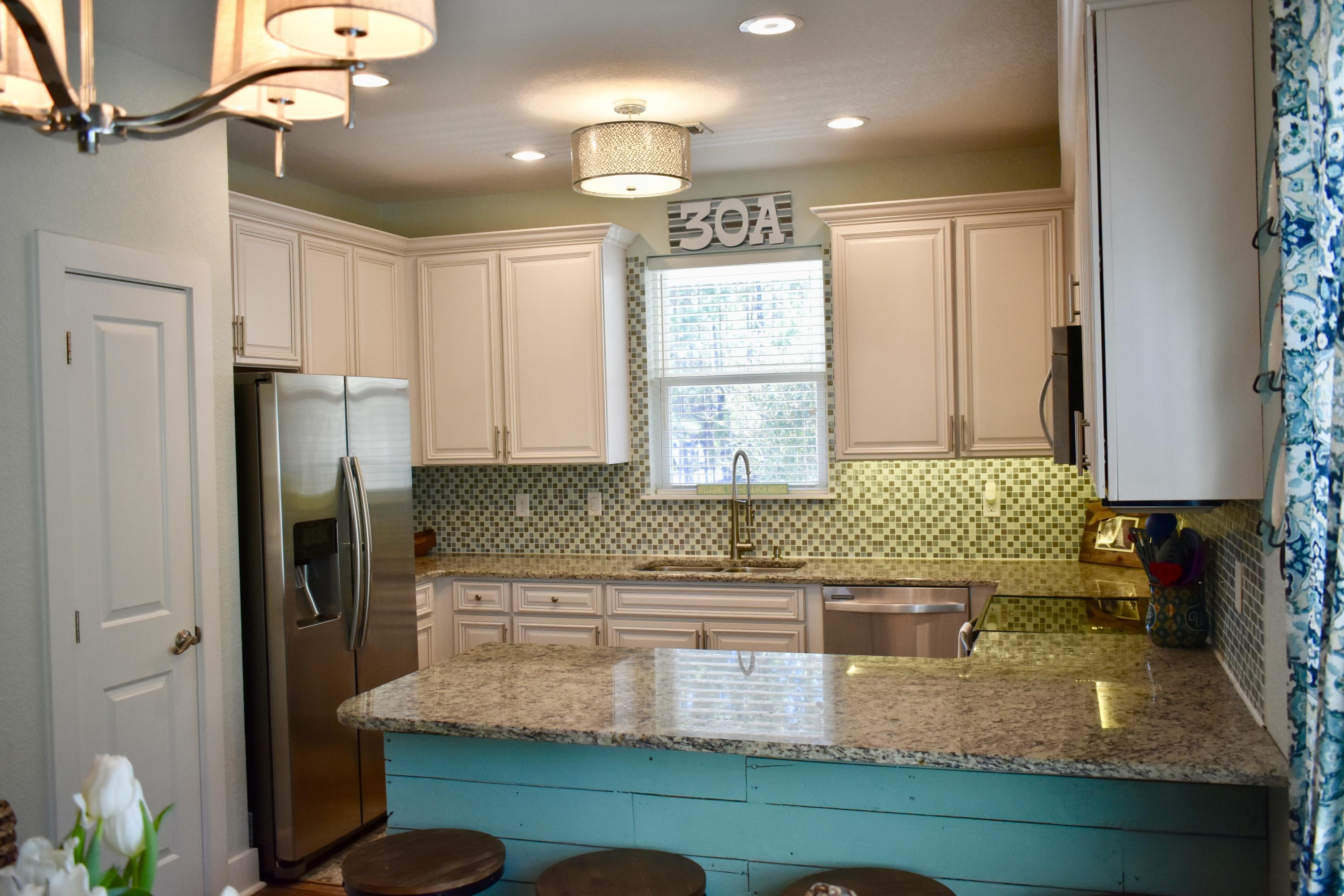 153 Spotted Dolphin Road Santa Rosa Beach, FL 32459 - Photo 17 of 36 a kitchen with kitchen island a counter appliances and a counter top space