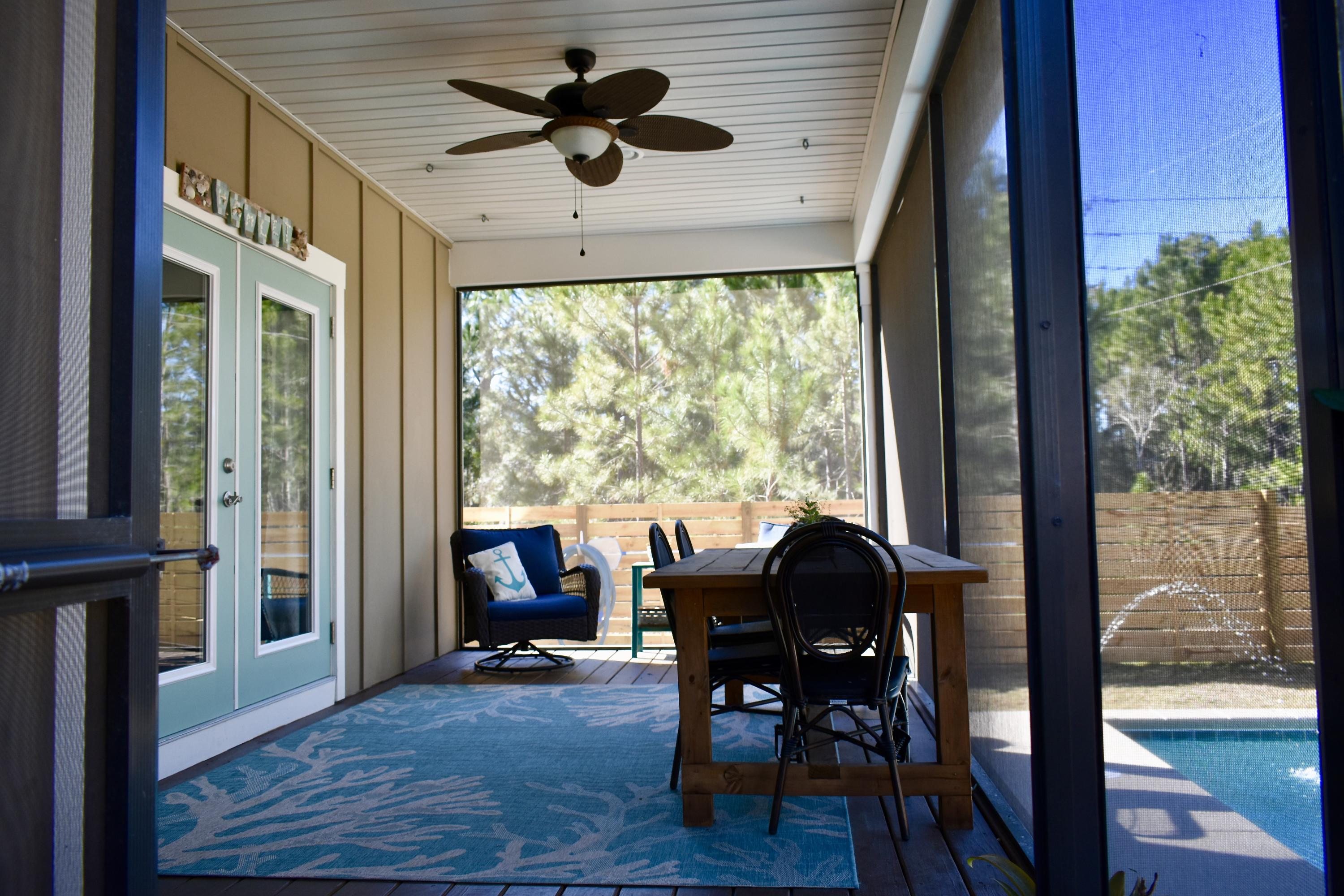 153 Spotted Dolphin Road Santa Rosa Beach, FL 32459 - Photo 3 of 36 a view of a dining room with furniture window and wooden floor