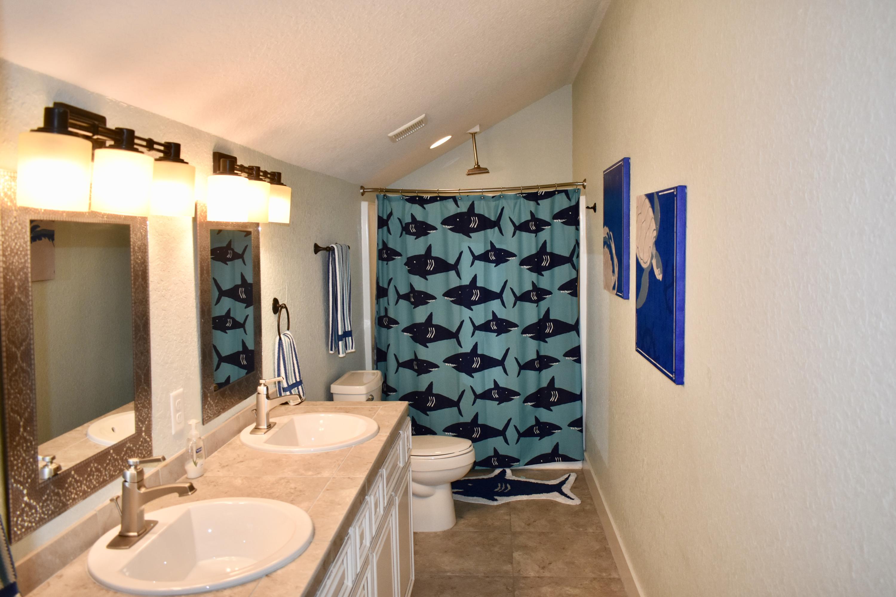 153 Spotted Dolphin Road Santa Rosa Beach, FL 32459 - Photo 31 of 36 a bathroom with a sink and a mirror