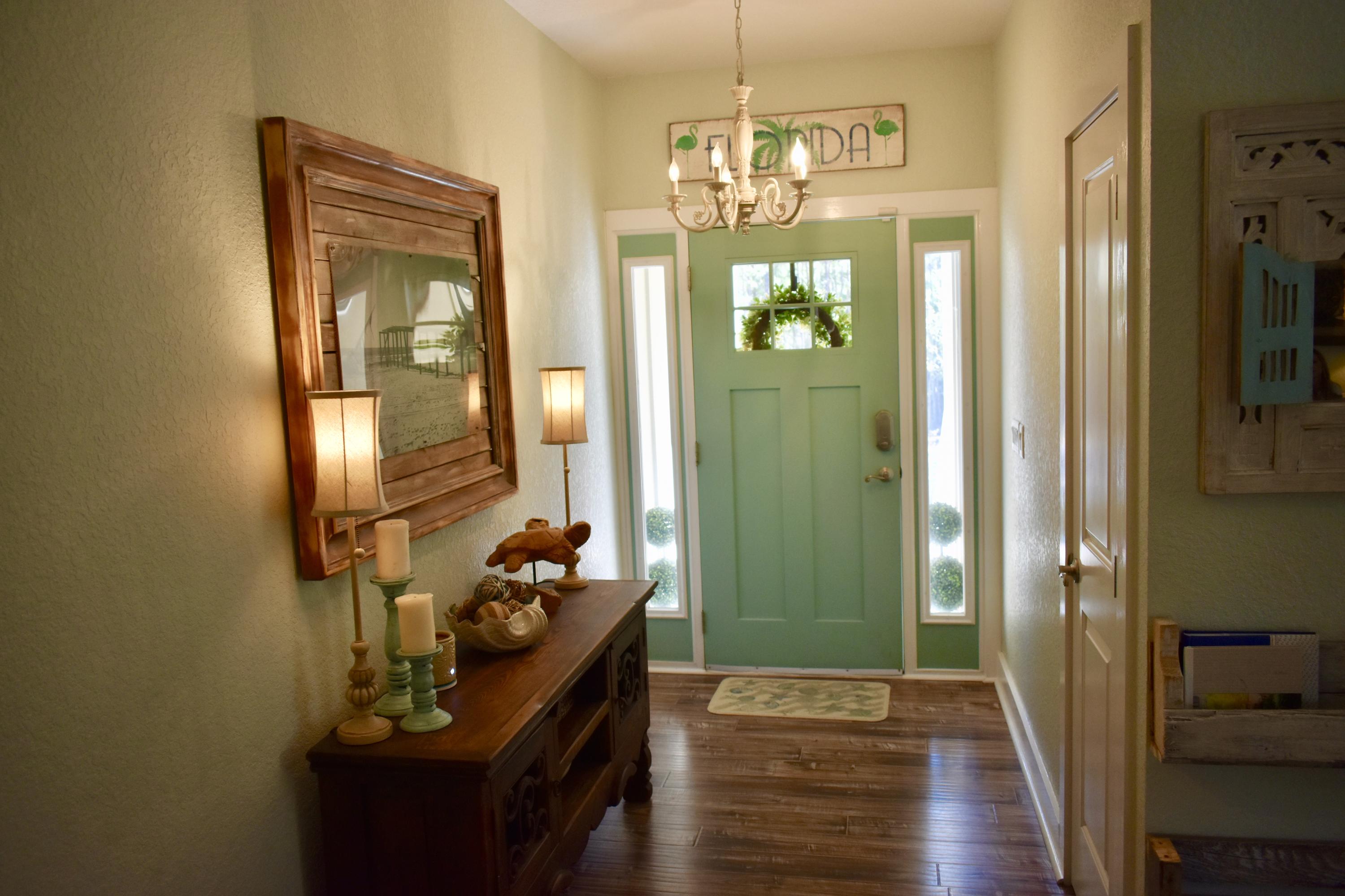 153 Spotted Dolphin Road Santa Rosa Beach, FL 32459 - Photo 10 of 36 a view of a hallway with wooden floor and stairs