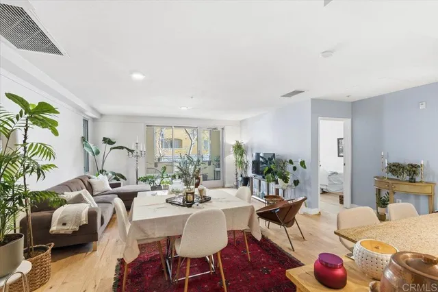a living room with furniture potted plant and a large window