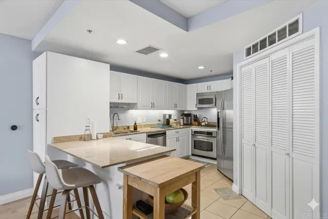 a kitchen with a stove a sink and a refrigerator