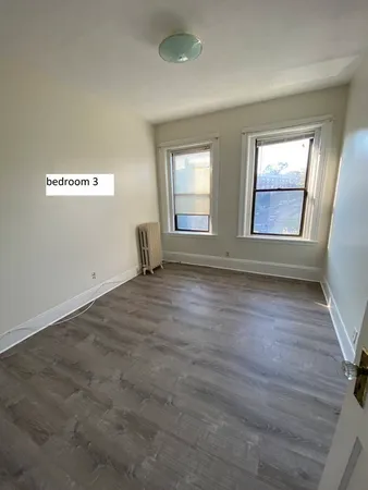 a view of a room with a sink and a mirror