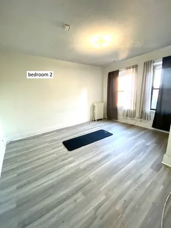 a view of a room with wooden floor and stairs