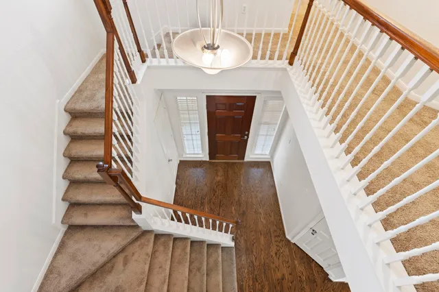 a view of entryway and hall with wooden floor