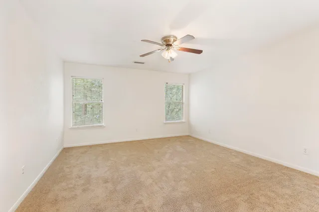 a view of room with a ceiling fan and window