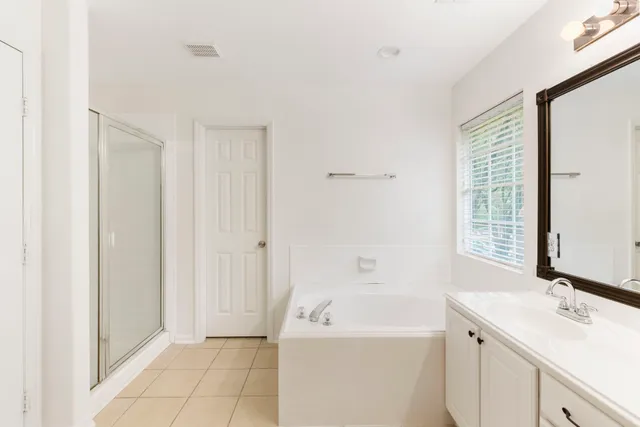 a bathroom with a bathtub a sink and a mirror
