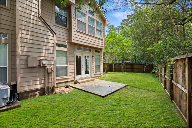 a front view of a house with yard and fence