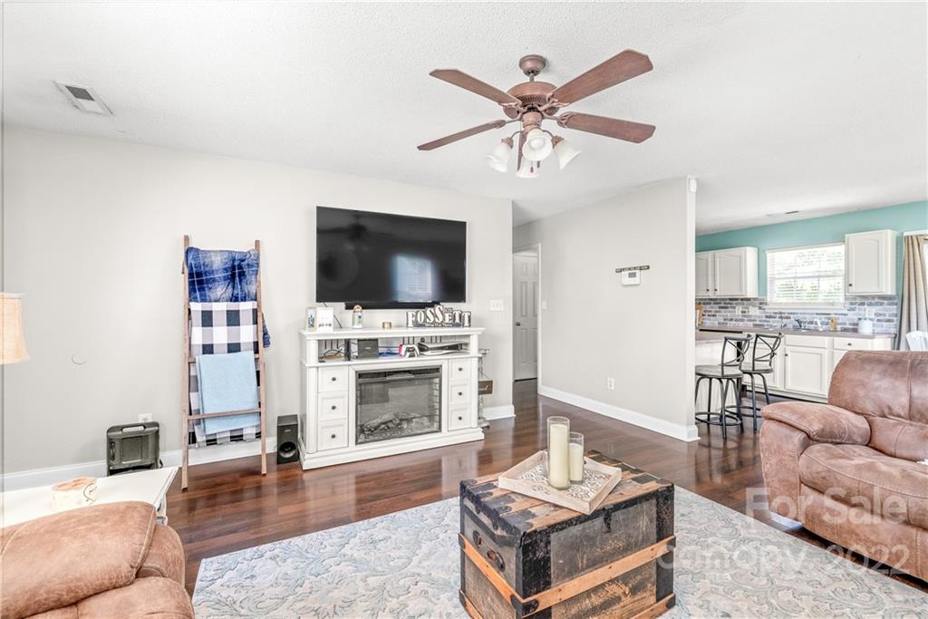 409 Funderburk Road Wingate, NC 28174 - Photo 6 of 22 a living room with furniture a flat screen tv and a fireplace