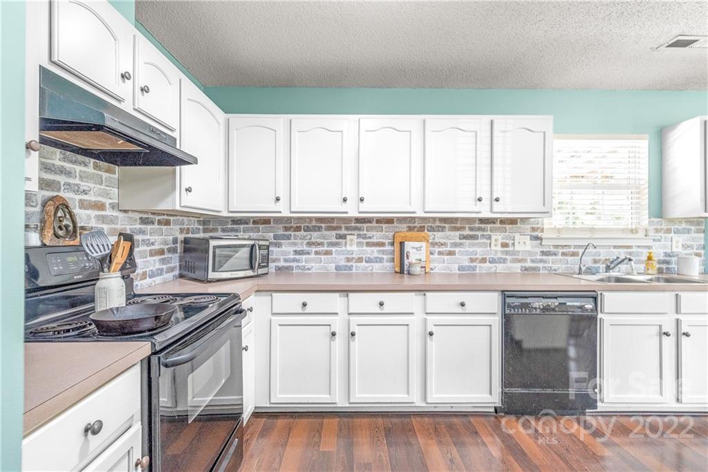 409 Funderburk Road Wingate, NC 28174 - Photo 10 of 22 a kitchen with granite countertop white cabinets and white appliances