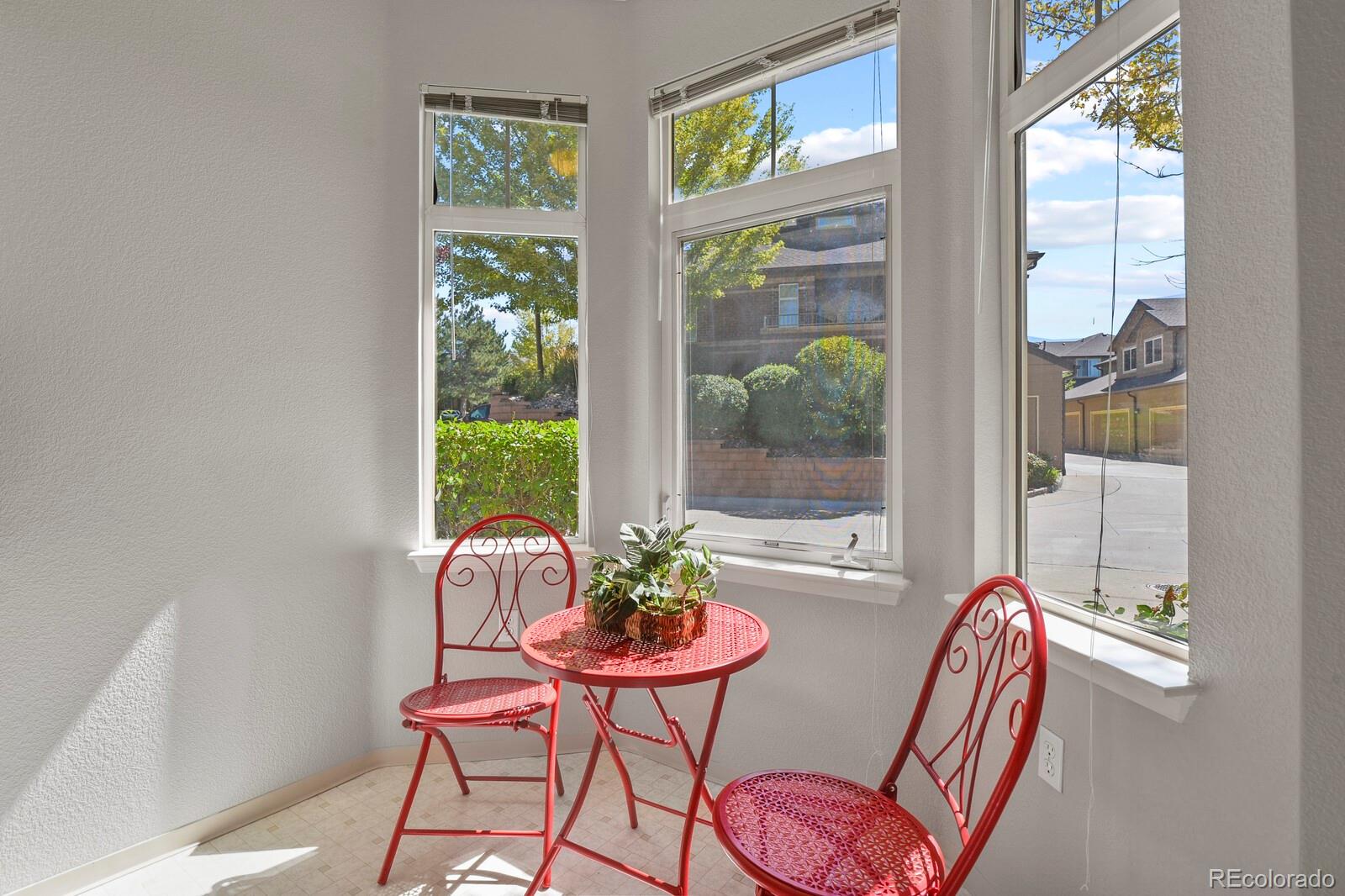 6444 Silver Mesa Drive, Unit A Highlands Ranch, CO 80130 - Photo 11 of 40 a dining room with furniture and a window