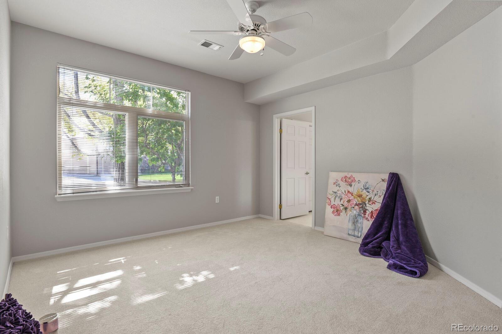 6444 Silver Mesa Drive, Unit A Highlands Ranch, CO 80130 - Photo 12 of 40 a view of room with window and ceiling fan