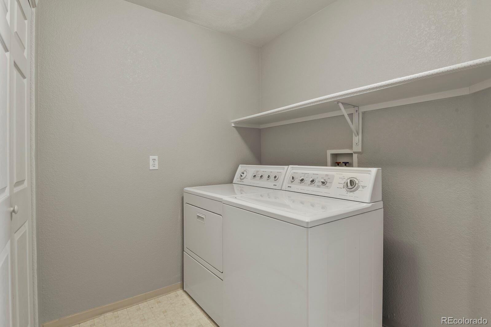 6444 Silver Mesa Drive, Unit A Highlands Ranch, CO 80130 - Photo 14 of 40 a utility room with dryer and washer