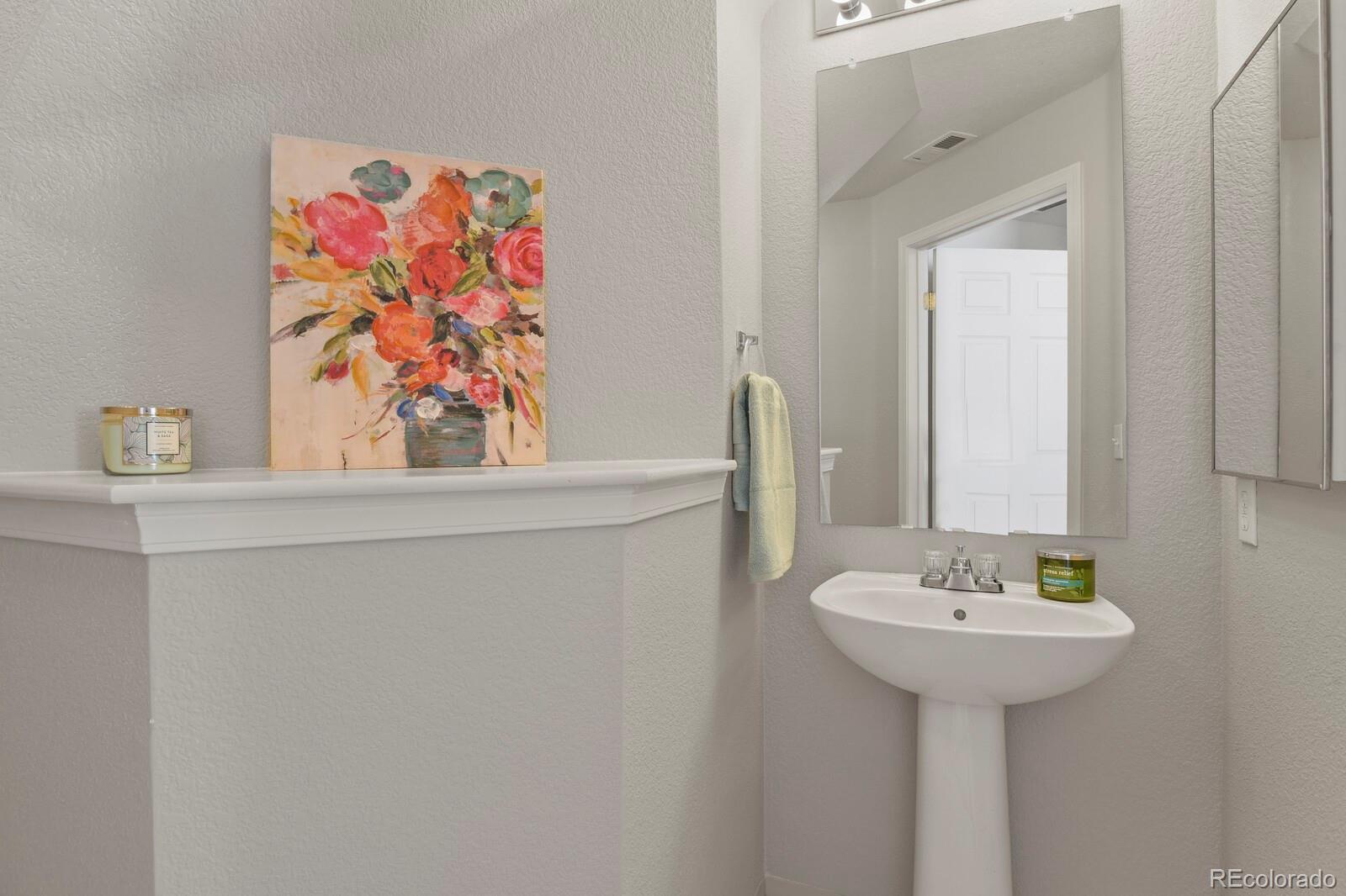 6444 Silver Mesa Drive, Unit A Highlands Ranch, CO 80130 - Photo 15 of 40 a bathroom with a sink and a mirror