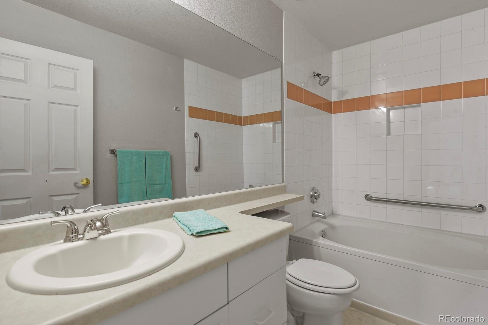 6444 Silver Mesa Drive, Unit A Highlands Ranch, CO 80130 - Photo 19 of 40 a bathroom with a granite countertop sink toilet and shower