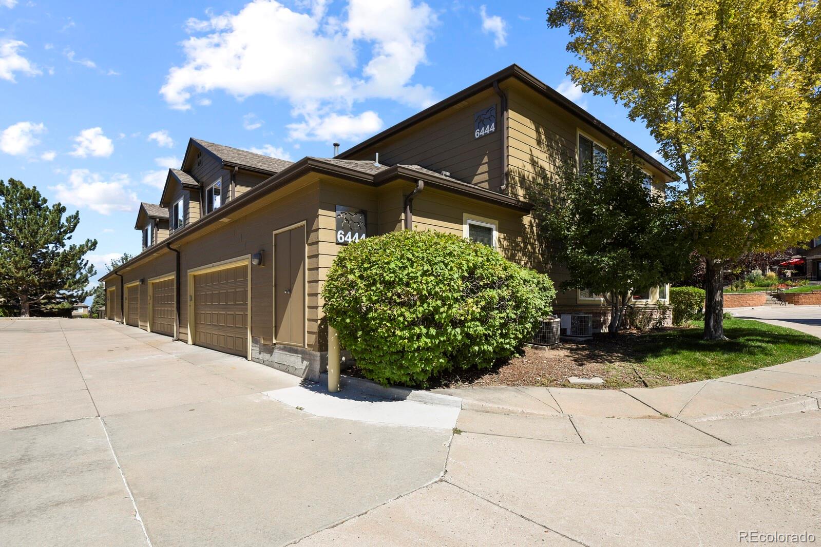 6444 Silver Mesa Drive, Unit A Highlands Ranch, CO 80130 - Photo 21 of 40 a front view of a house with garden
