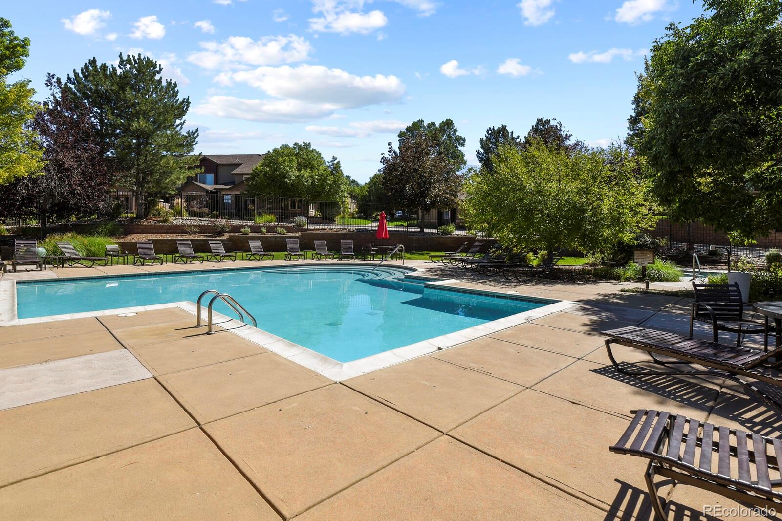 6444 Silver Mesa Drive, Unit A Highlands Ranch, CO 80130 - Photo 25 of 40 a view of a swimming pool and lounge chairs