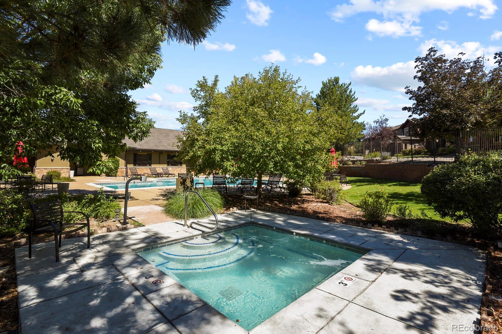 6444 Silver Mesa Drive, Unit A Highlands Ranch, CO 80130 - Photo 27 of 40 a backyard of a house with swimming pool and outdoor seating