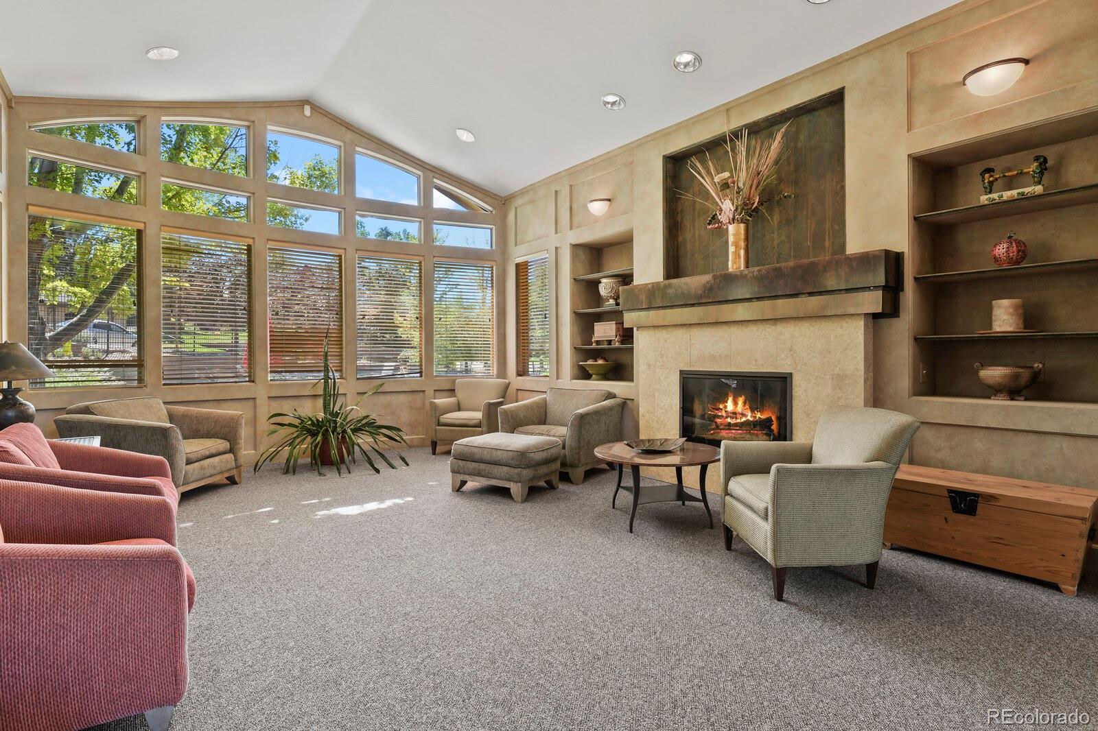 6444 Silver Mesa Drive, Unit A Highlands Ranch, CO 80130 - Photo 28 of 40 a living room with furniture and a fireplace