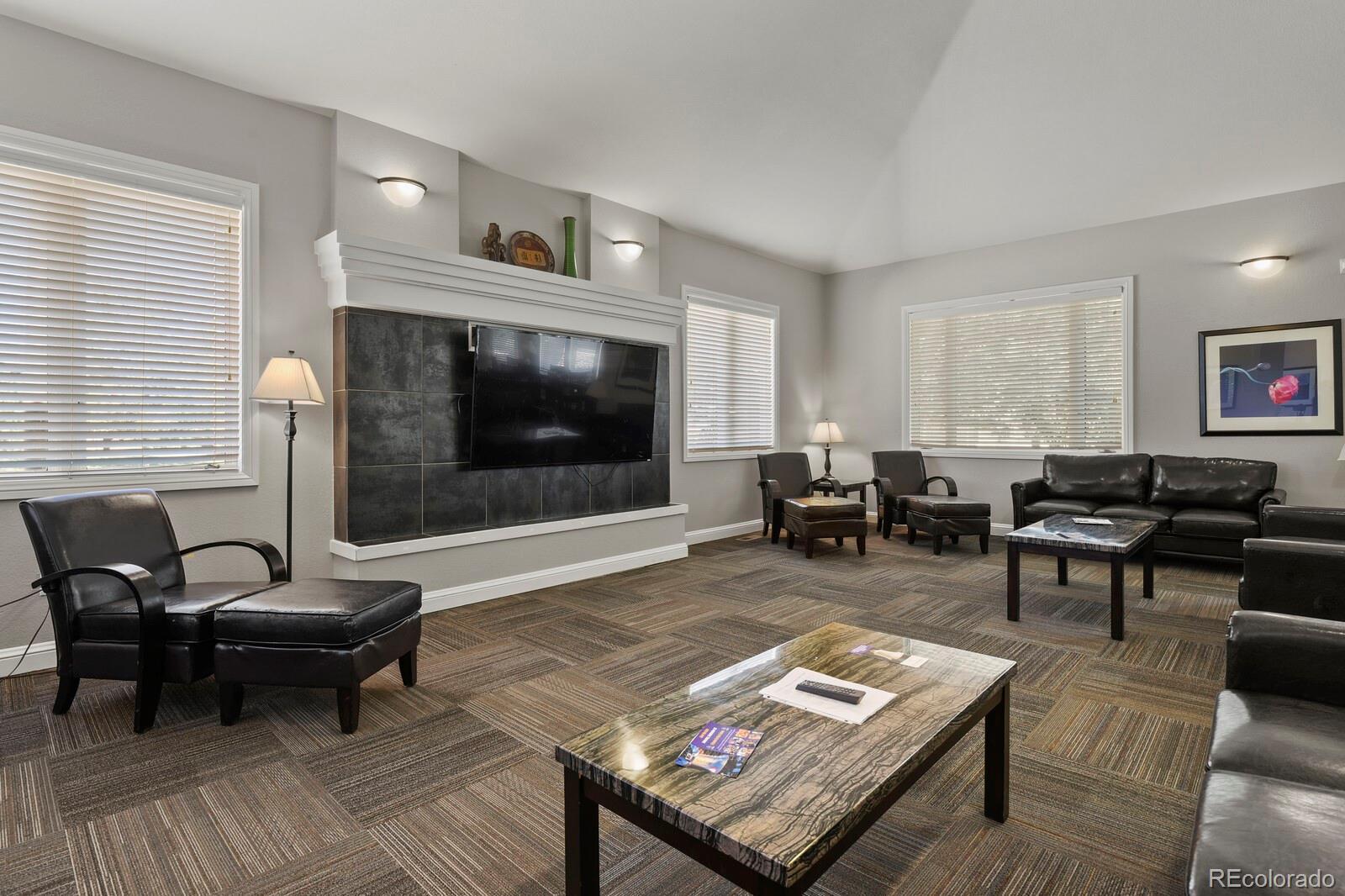 6444 Silver Mesa Drive, Unit A Highlands Ranch, CO 80130 - Photo 30 of 40 a living room with furniture and a fireplace