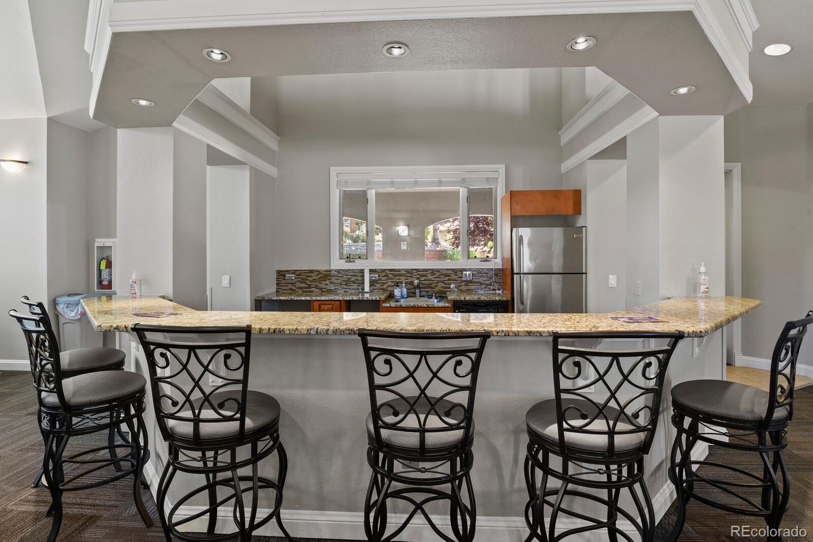 6444 Silver Mesa Drive, Unit A Highlands Ranch, CO 80130 - Photo 31 of 40 a kitchen with a table and chairs in it