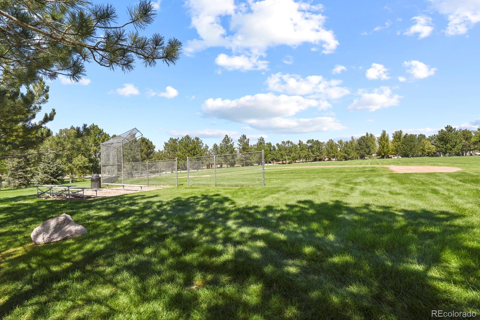 6444 Silver Mesa Drive, Unit A Highlands Ranch, CO 80130 - Photo 37 of 40 a view of a green field with lots of trees