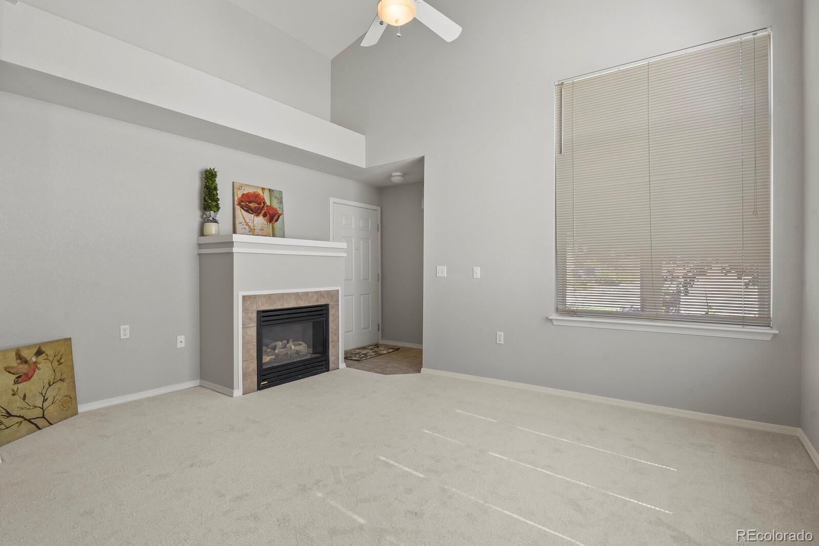 6444 Silver Mesa Drive, Unit A Highlands Ranch, CO 80130 - Photo 5 of 40 a view of a livingroom with a fireplace and window