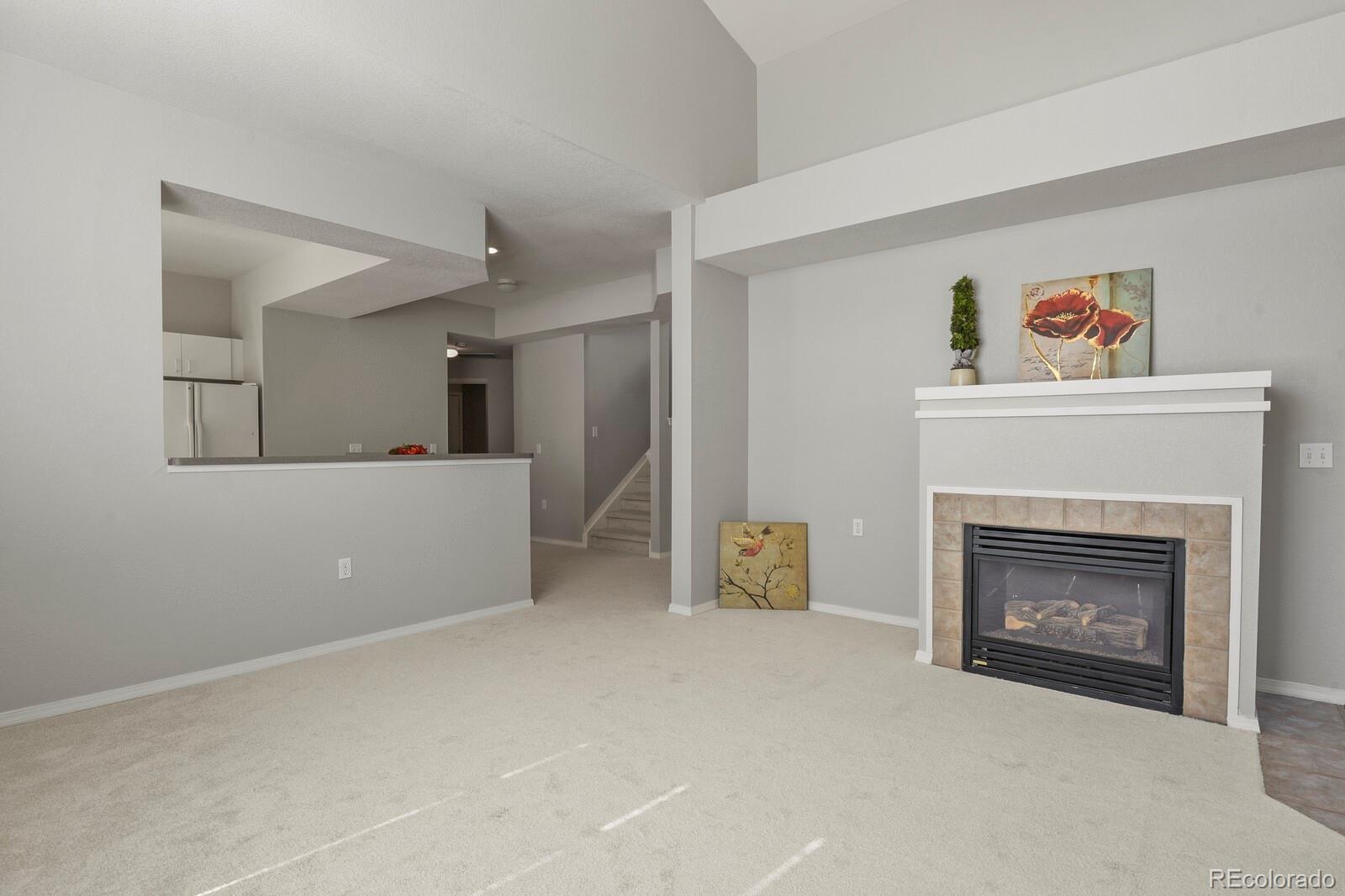 6444 Silver Mesa Drive, Unit A Highlands Ranch, CO 80130 - Photo 6 of 40 a view of a livingroom with furniture and a fireplace