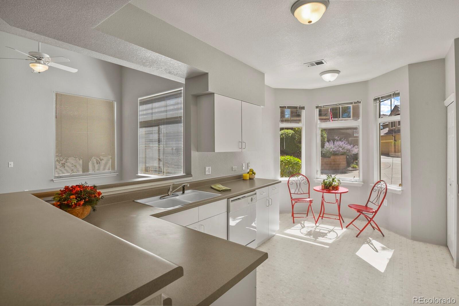 6444 Silver Mesa Drive, Unit A Highlands Ranch, CO 80130 - Photo 8 of 40 a living room with dining table and a large window