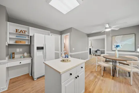 a kitchen with stainless steel appliances white cabinets and a window