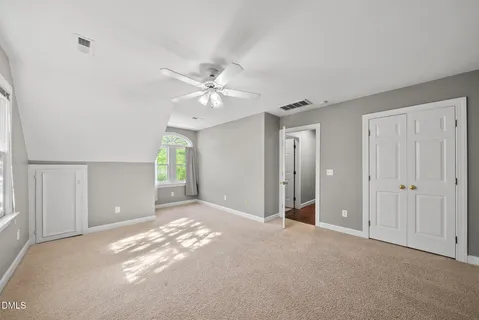 a view of a livingroom with a ceiling fan and window