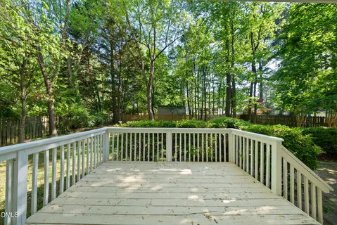 a view of balcony with wooden floor and fence