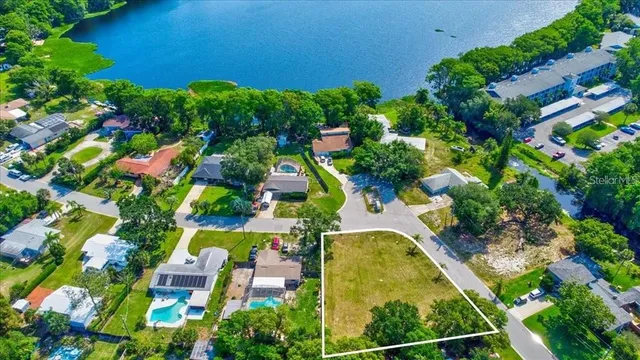 an aerial view of residential houses with outdoor space and street view