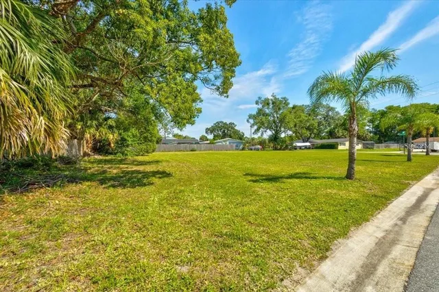 a view of yard with swimming pool and green space