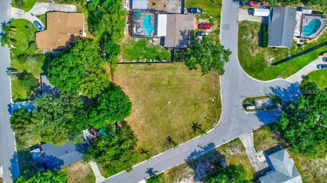 an aerial view of residential house with outdoor space and swimming pool