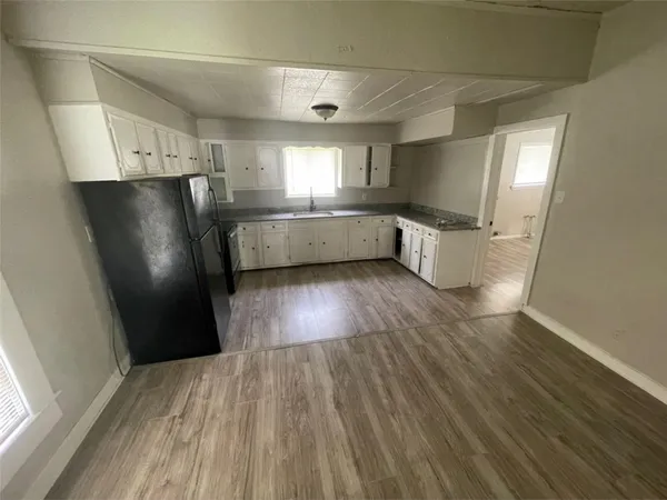 a view of a refrigerator in kitchen and wooden floor