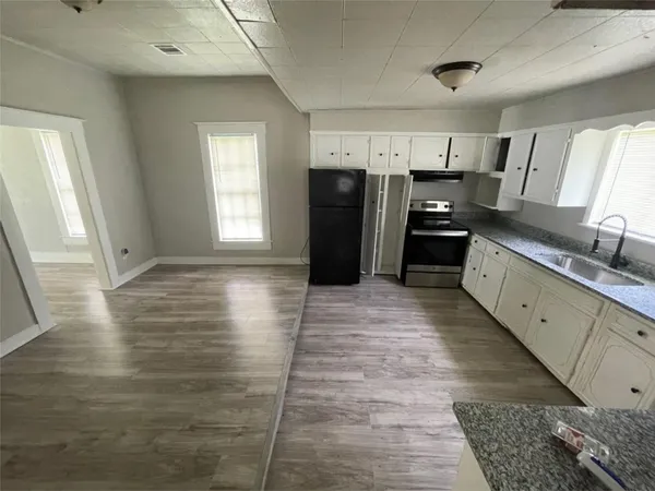 a large bathroom with a glass door shower and a sink