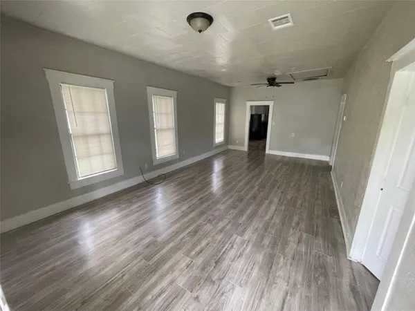wooden floor in an empty room with a window