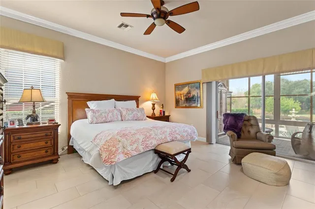 a bedroom with a bed and large window