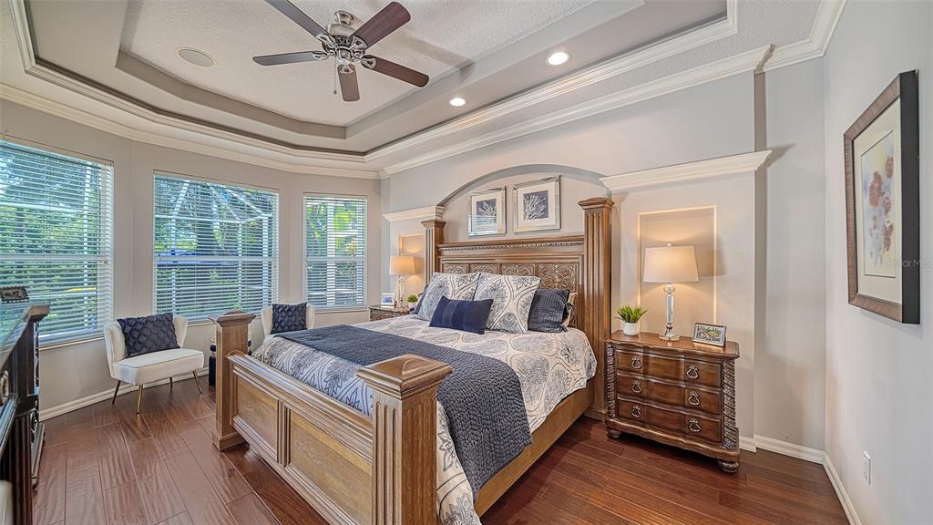 12202 Lobelia Terrace Lakewood Ranch, FL 34202 - Photo 19 of 80 a bedroom with a bed and a chandelier