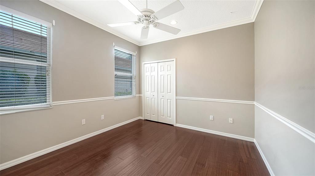12202 Lobelia Terrace Lakewood Ranch, FL 34202 - Photo 56 of 80 an empty room with wooden floor and windows