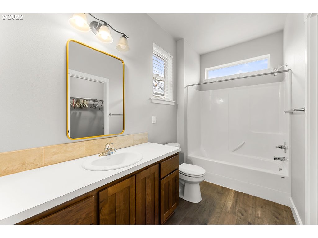 4593 North Noble Loop Ridgefield, WA 98642 - Photo 11 of 22 a bathroom with a sink a toilet a shower and a mirror