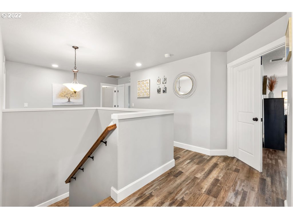 4593 North Noble Loop Ridgefield, WA 98642 - Photo 12 of 22 a view of a hallway with stairs and wooden floor