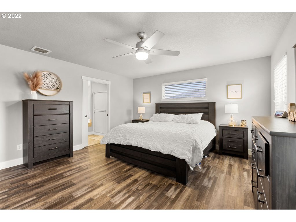 4593 North Noble Loop Ridgefield, WA 98642 - Photo 15 of 22 a bedroom with a bed and a chandelier