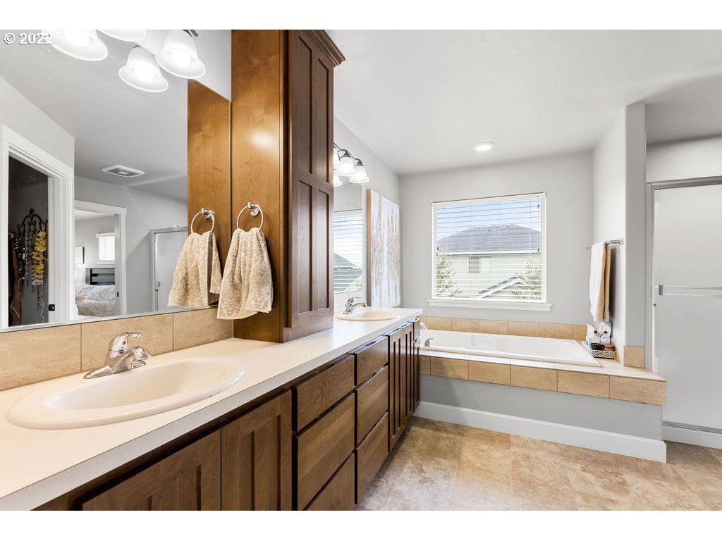 4593 North Noble Loop Ridgefield, WA 98642 - Photo 17 of 22 a bathroom with a bathtub sink and mirror