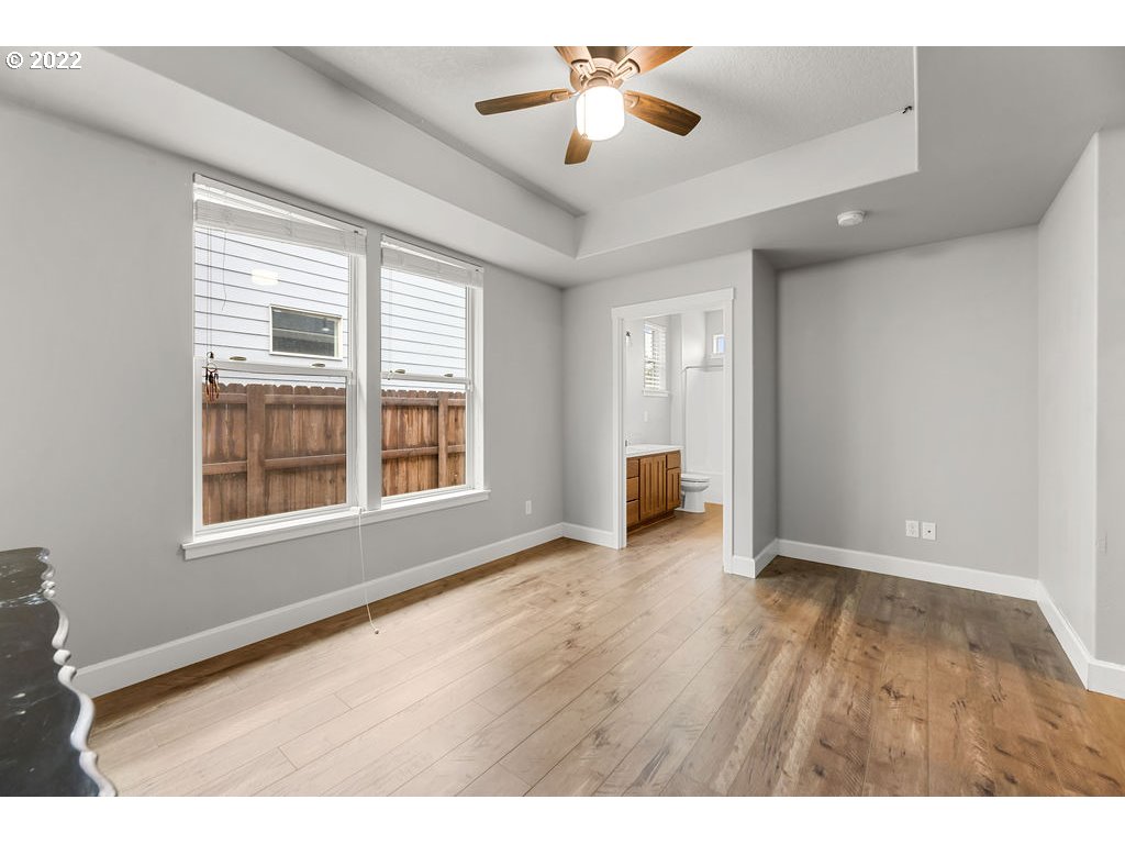 4593 North Noble Loop Ridgefield, WA 98642 - Photo 10 of 22 a view of an empty room with a window and wooden floor