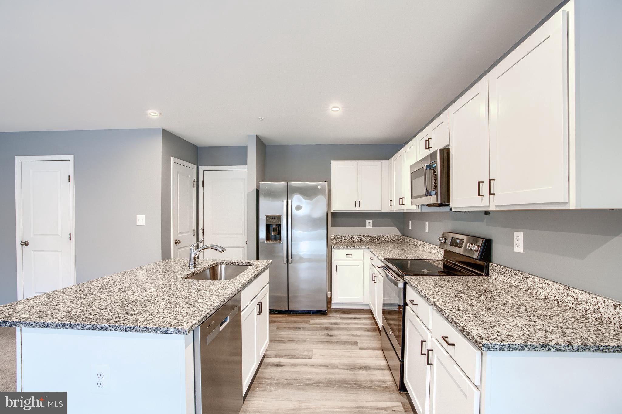 104 Magnolia Drive Elkton, MD 21921 - Photo 11 of 52 a kitchen with stainless steel appliances granite countertop a sink stove and refrigerator